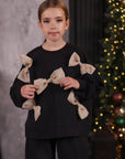 Suit with bows